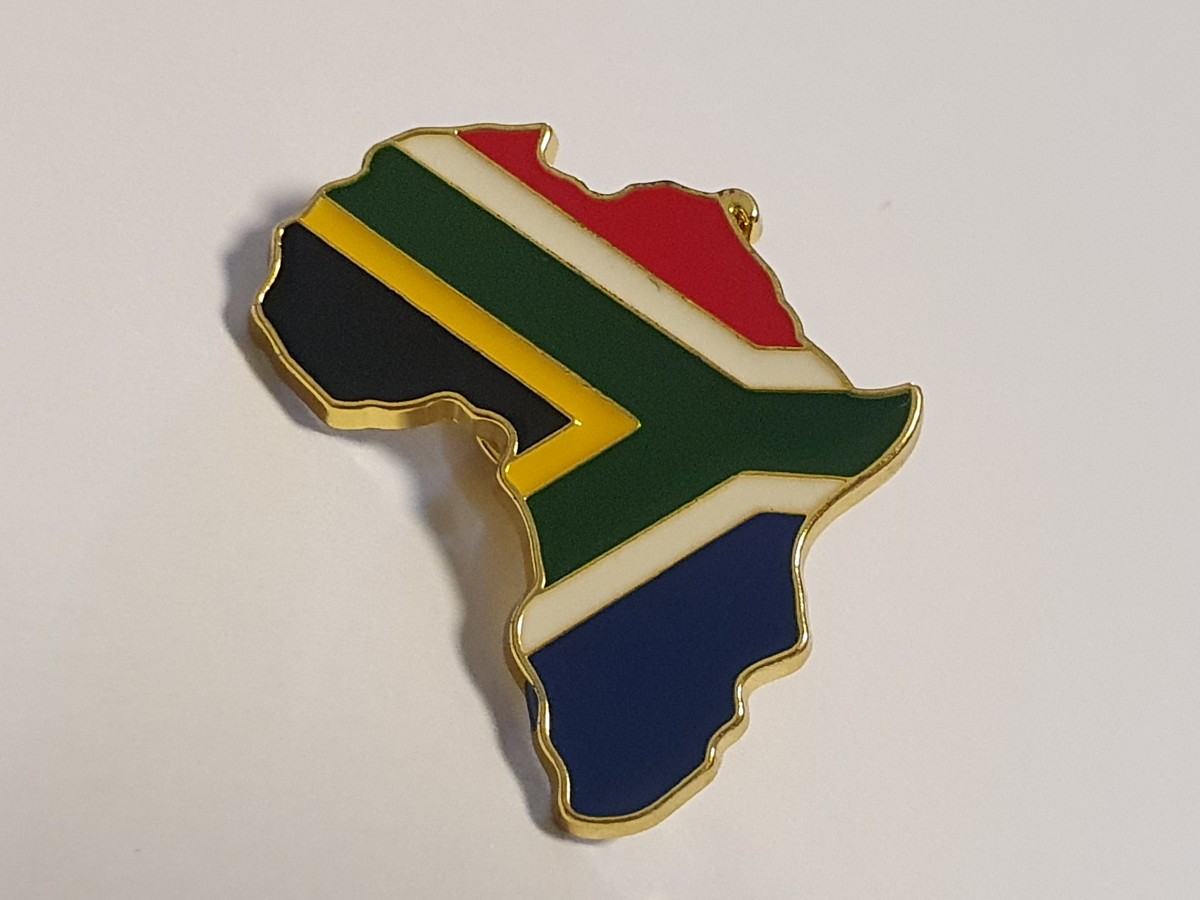 Africa-shaped metal lapel pin with the South African flag in colourful enamel and gold-tone edging