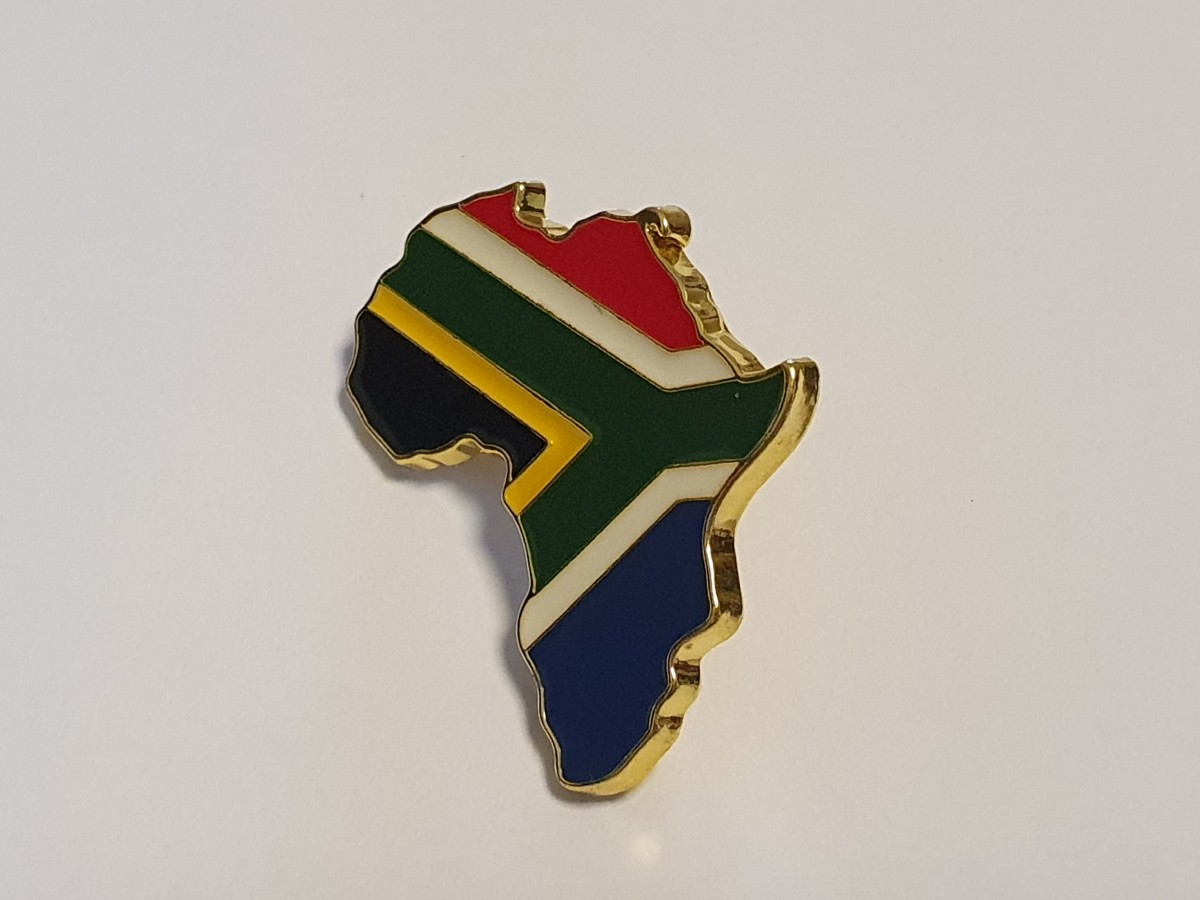 Angled view showing the enamel face and gold-tone edge of the Africa-shaped South African flag pin